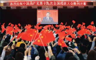  ?? Picture: AP ?? POPULAR: Students wave flags as they watch a speech by Chinese President Xi Jinping during the opening ceremony of China’s 19th Party Congress in Huaibei in eastern China’s Anhui province.