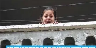  ?? —AFP ?? GAZA: A relative of 29-year-old Saadi Abu Taha, who was killed at the Israel-Gaza border during protests, mourns while looking out of a balcony in Khan Yunis in the southern Gaza strip yesterday.