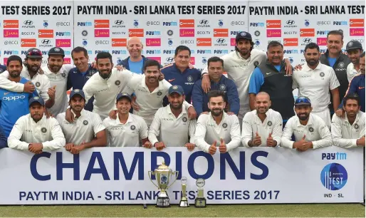  ?? PTI ?? Indian players pose with the winning trophy after the third Test against Sri Lanka ended in draw, in New Delhi, on Wednesday. India went on to win the series 1-0. —