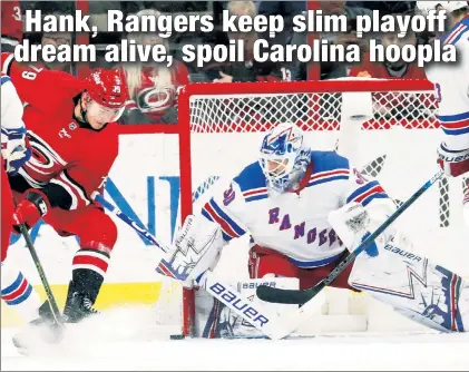  ?? AP ?? Henrik Lundqvist, who made 43 saves in just his second start in five games, stops a shot by the Hurricanes’ Micheal Ferland during the Rangers’ 2-1 victory Tuesday night at Carolina.