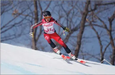  ?? The Canadian Press ?? Erin Latimer of Canada speeds down the course during the standing women’s downhill at Jeongseon Alpine Centre during the Paralympic Winter Games on Saturday in PyeongChan­g, South Korea.