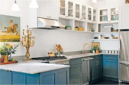  ?? HOUZZ ?? ABOVE: Although white will always be a classic color for kitchen design, homeowners are shying away from bland hues and injecting rich colors such as warm wood tones and neutrals.