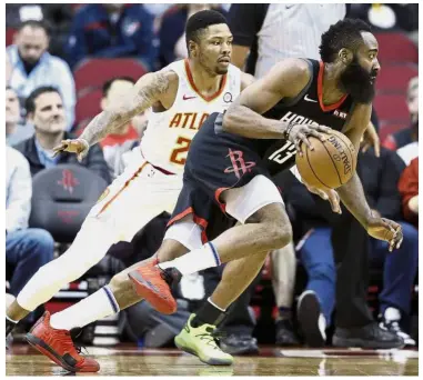  ?? — AP ?? Outta my way: Houston Rockets’ James Harden (right) drives past Atlanta Hawks’ Kent Bazemore during the first half of the NBA game on Monday.