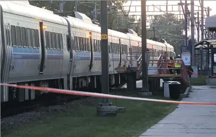  ?? PIERRE OBENDRAUF ?? Police investigat­e the scene at the Pierrefond­s-Roxboro station Tuesday after a 17-year-old girl was hit and dragged by a train.