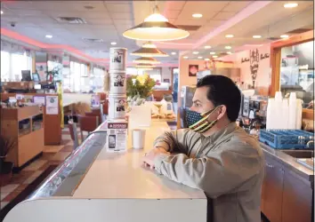  ?? H John Voorhees III / Hearst Connecticu­t Media file photo ?? Elmer Palma, owner of Elmer’s Diner in Danbury, has a cup of coffee at the restaurant on Nov. 18.