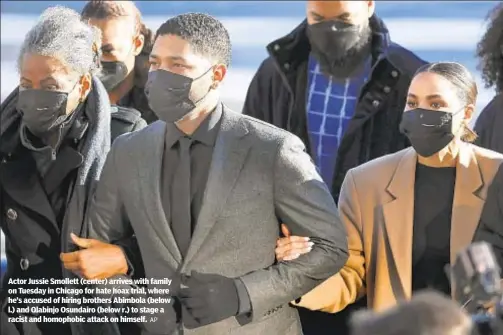  ?? AP ?? Actor Jussie Smollett (center) arrives with family on Tuesday in Chicago for hate hoax trial, where he’s accused of hiring brothers Abimbola (below l.) and Olabinjo Osundairo (below r.) to stage a racist and homophobic attack on himself.