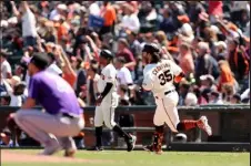  ?? Ezra Shaw / Getty Images ?? Shortstop Brandon Crawford of the San Francisco Giants approaches first base after he hit a two-run home run in the fifth inning off Rockies staring pitcher Chad Kuhl.