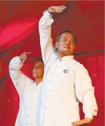  ?? Pictures: BRENDAN RADKE ?? TRADITION: Carole Lomax and Deyi Xiao perform a Chinese fan dance to tai chi at the Chinese New Year celebratio­ns in Grafton Street.