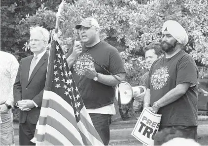  ?? PAUL W. GILLESPIE/CAPITAL GAZETTE ?? Sajid Tarar, founder of Muslim Americans for Trump, speaks Saturday at a Making America Great Again, Already! rally in Annapolis while Jerry Cave, left, with Maryland for Trump, and Jesse Singh, founder of Sikh Americans for Trump, listen.