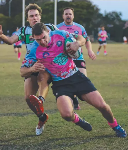  ?? Picture: GLENN HAMPSON ?? Helesvale’s Tom Eastwell keeps Palm Beach defender Corey Morris at bay to score on Saturday.