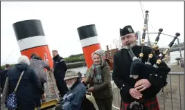  ??  ?? Passengers look forward to the journey, while a piper is on hand for the special occasion ahead of the Waverley paddle steamer retracing its original 1947 journey