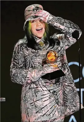  ?? AP PHOTO/CHRIS PIZZELLO ?? Billie Eilish reacts as she accepts the award for record of the year for “Everything I Wanted” at the 63rd annual Grammy Awards at the Los Angeles Convention Center on Sunday, March 14, 2021.