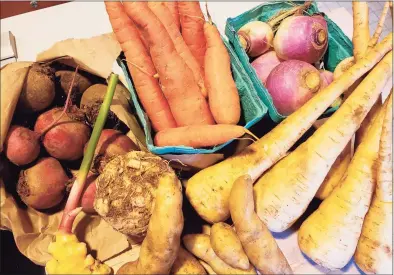  ?? Frank Whitman / For Hearst Connecticu­t Media ?? Turnips, parsnips, celeriac and rutabagas along with freshly dug potatoes and ginger from the Westport Farmers Market.