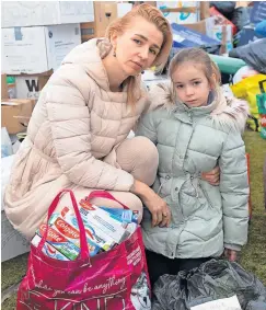  ?? ?? Refugees Natasha Kukharchuk and her six-year-old daughter Sophie are now helping at the donation centre in Motherwell