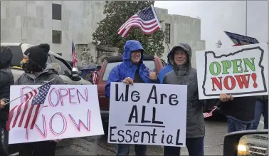  ?? ANDREW SELSKY — THE ASSOCIATED PRESS ?? People at the state capital in Salem, Oregon, protest Gov. Kate Brown’s executive order that shut down much of the state’s economy and imposed social distancing. The CBO is forecastin­g a plunge of 40% in the overall economy this quarter.