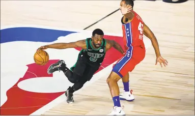  ?? Ashley Landis / Associated Press ?? The Celtics’ Kemba Walker, left, drives around the 76ers’ Al Horford during the first half their first round playoff game on Monday in Lake Buena Vista, Fla.