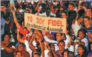  ?? REUTERS ?? People hold a sign reading in Spanish “I am Fidel” during a Saturday event commemorat­ing the first anniversar­y of the death of Cuban President Fidel Castro, in Havana. Cubans mourned Castro’s death with political and cultural events.