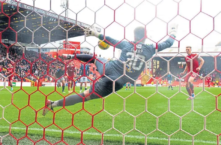  ?? ?? AND RELAX .... Aberdeen’s Lewis Ferguson fires home the penalty to give the Reds victory over bottom club Dundee at Pittodrie and ease the home side’s relegation play-off fears.