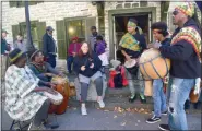  ?? TANIA BARRICKLO — DAILY FREEMAN ?? Members of the Kingston-based Center for Creative Education and Juma Sultan, far left, a musician who tries to increase the understand­ing of music in the context of African and Afro-American cultures, drum outside of the Persen house on John Street in Uptown Kingston, N.Y., during the Autumn Festival on Saturday