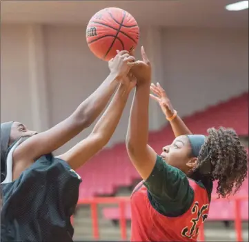  ?? PHOTOS BY WILLIAM HARVEY/RIVER VALLEY & OZARK EDITION ?? Russellvil­le juniors Taneka Boyce, left, and Makayla Ealy battle for the ball.