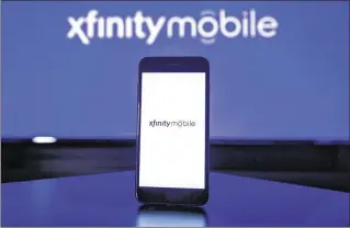  ?? JEFF FUSCO / ASSOCIATED PRESS ?? Comcast’s Xfinity Mobile will be available as part of a four-service bundle.
