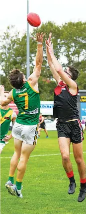  ?? ?? Flying for a mark are Leongatha’s Jackson Harry and Warragul’s Cooper Alger.