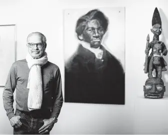  ?? Marie D. De Jesús / Staff photograph­er ?? Andy Moran, shown near a charcoal piece of Frederick Douglass by Julian Joseph Kyle , has spent years investing in art by painters who were based at Texas Southern University.