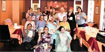  ??  ?? Parveen (squatting centre), Dr Manju (standing at right), Harnaik (seated second right) and others in a photo call after celebratin­g Mother’s Day.