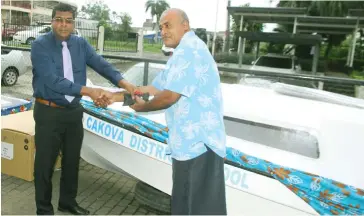  ?? Photo: Kathrin Krishna ?? Minister for Education Mahendra Reddy (left) handing over the boat to Filipe Jitoko outside Waisomo House in Suva on June 28, 2017.