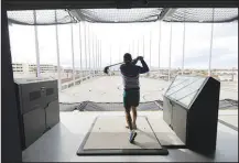  ?? STEVE MARCUS ?? Brett Jones of Las Vegas tees off March 29 at Atomic Golf, a new golf and entertainm­ent venue. Atomic Golf is one of several newly opened or planned sports-entertainm­ent complexes for the Las Vegas area.