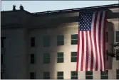  ?? JACQUELYN MARTIN — THE ASSOCIATED PRESS FILE ?? An American flag is draped on the side of the Pentagon where the building was attacked on the 14th anniversar­y of the Sept. 11attack.