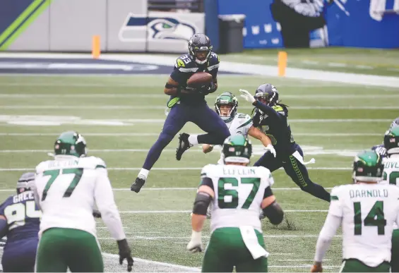  ?? ABBIE PARR/ GETTY IMAGES ?? Seattle's Jamal Adams breaks up a pass intended for Braxton Berrios of the New York Jets during the first quarter Sunday at Lumen Field in Seattle.