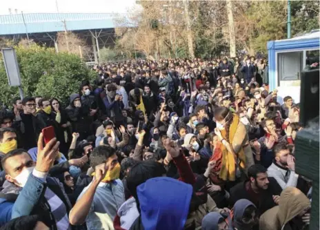  ?? THE ASSOCIATED PRESS ?? University students attend a protest Saturday at Tehran University while anti-riot Iranian police prevent them from joining other protesters.