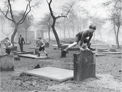  ?? Picture: GETTY ?? High jinx: Boys from the Gorbals play in a cemetery in Glasgow in 1948