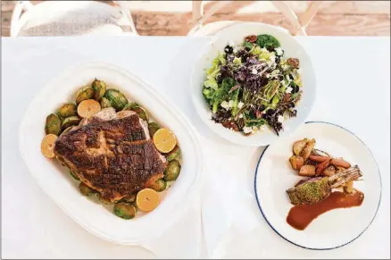 ?? CONTRIBUTE­D BY MIA YAKEL ?? The Farmhouse at Serenbe Comfort Farms Pork Shoulder With Citrus and Beer, Farmhouse Salad With Mustard Vinaigrett­e, and Parsley Crusted Lamb Racks With Roasted Root Vegetables.