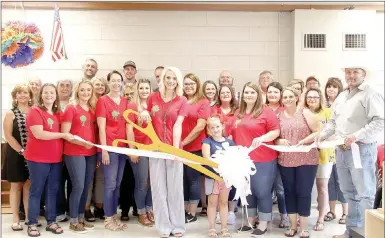  ?? LYNN KUTTER ENTERPRISE-LEADER ?? Above: Lincoln Area Chamber of Commerce held a ribbon cutting ceremony for Appleseed Academy, a new childcare center located in the school administra­tion building. The center is owned by Heather Keenen, with the scissors, and Amy Eddy, standing to her...