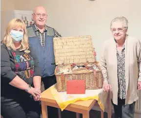 ?? ?? Well stocked Alison Grieve, of Airdrie and Coatbridge Specsavers stores, delivers the hamper to Bob and Betsy