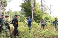 ?? SUPPLIED ?? Military Police and environmen­tal rangers are seen inspecting the disputed land clearing in a protected area supported by the Maddox Jolie-Pitt Foundation in Pailin province in January.