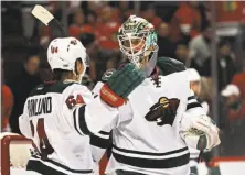  ?? Jonathan Daniel / Getty Images ?? The Wild’s Mikael Granlund greets goaltender Devan Dubnyk after Minnesota defeated Chicago for the eighth straight time.