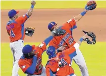  ?? AP FILE ?? Members of the Dominican Republic team celebrate a 3-1 win over the United States during the 2013 Classic.