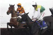  ?? — AP ?? CHELTENHAM: Many Clouds ridden by Leighton Aspell, right, jump an early fence in company with Thistlecra­ck ridden by Tom Scudamore before going on to win The Cotswold Chase Race run during Festival Trials Day at Cheltenham Racecourse, in Cheltenham,...