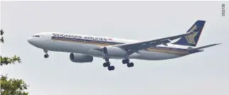  ??  ?? A SINGAPORE AIRLINES Airbus A330-300 airplane approaches to land at Changi Internatio­nal Airport in Singapore, June 10.