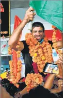  ??  ?? (Clockwise from above) Wrestler Ravi Dahiya being received by fans after the Indian Olympic contingent landed in New Delhi on Monday evening. The Indian women’s hockey team, Olympic champion Neeraj Chopra showing the gold medal to the crowd, wrestler Bajrang Punia being carried on the shoulders of well wishers and hockey player Rupinder Pal Singh clicking a selfie with Chopra and the crowd on arrival at the IGI Airport.