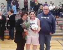  ?? Photo by Branden Mello ?? Bracketed by her parents, Tina and Randy, Mount senior Katie Lynch celebrated her 1,000th career point Wednesday night.