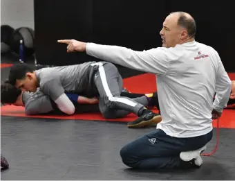  ?? CHRIS CHRISTO / BOSTON HERALD ?? GRAPPLING WITH SUCCESS: Natick coach Bob Anniballi works with his squad at a recent practice.