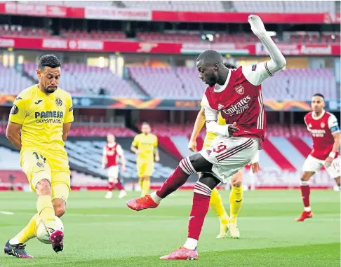  ??  ?? NO WAY THROUGH: Nicolas Pepe sees his shot blocked on a frustratin­g night for Arsenal in the Europa League semis.