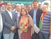  ?? HT ?? Former minister Anil Joshi ((left) with BJP candidate Preeti Taneja after she filed her papers in Amritsar on Wednesday.