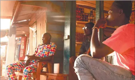  ?? Photo: Nampa/AFP ?? United we stand… Shopkeeper­s sit outside their shops in Bambari, Central African Republic.