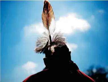  ?? [PHOTOS BY SARAH PHIPPS, THE OKLAHOMAN] ?? ABOVE: The Three Sisters Celebratio­n Sunday at the Chickasaw Cultural Center in Sulphur celebrates the changing of the seasons from winter to summer. ABOVE LEFT: Daniel Walker plays a game of social stickball.