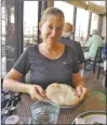  ?? Courtesy photo ?? Writer and former Taoseña Teresa Dovalpage enjoys ‘bread of life’ in Egypt.